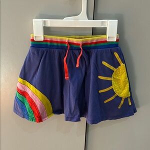 Mini Boden navy skort with rainbow waistband and yellow sun